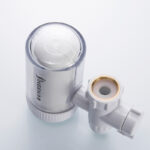 White tap water purifier mounted on a kitchen faucet